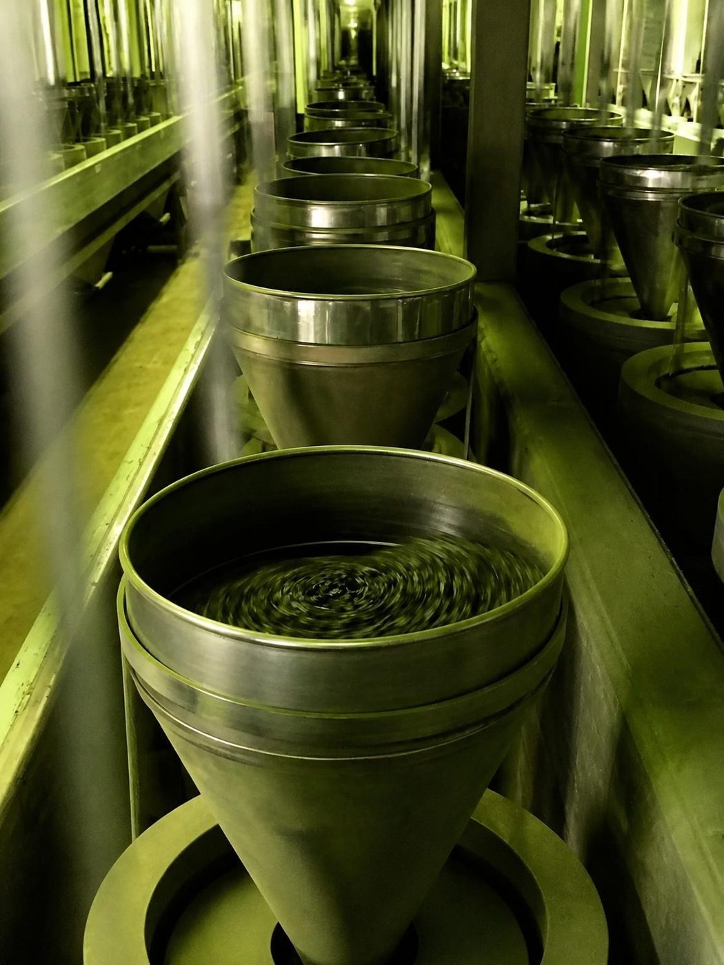 Traditional granite stone mill grinding tencha into matcha powder