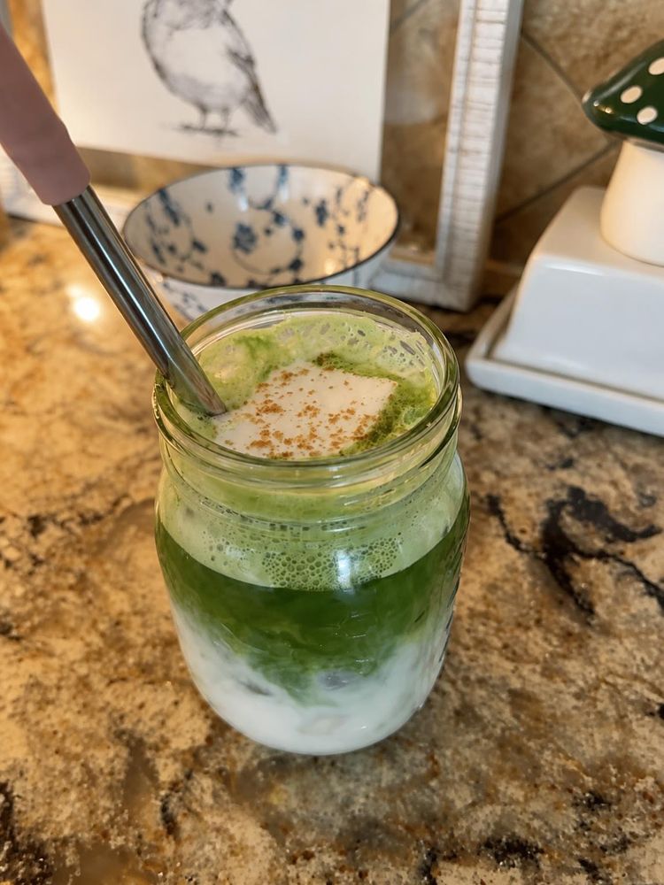 Mason jar of matcha with Lion's Mane mushroom powder layered with milk